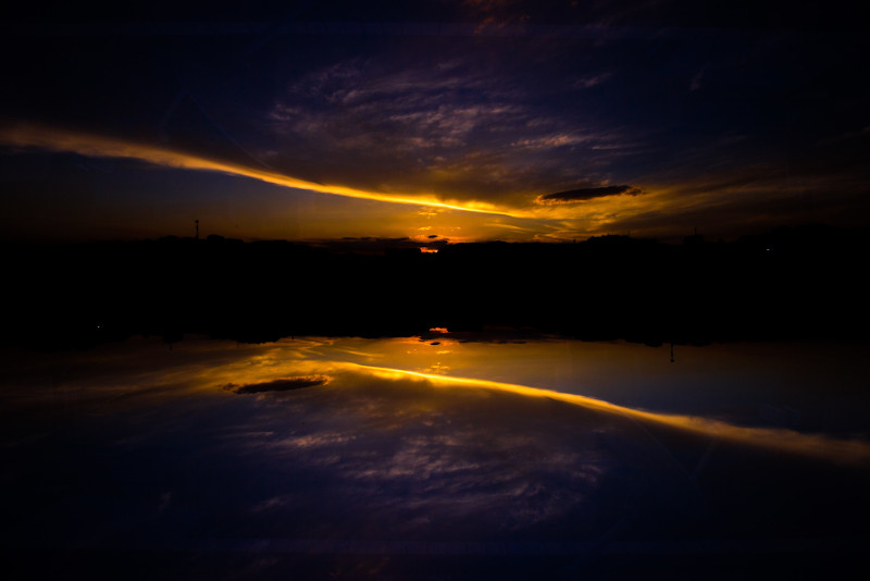 orange sunset reflected into a lake