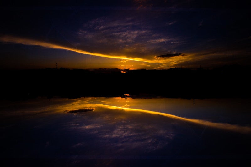 orange sunset reflected into a lake